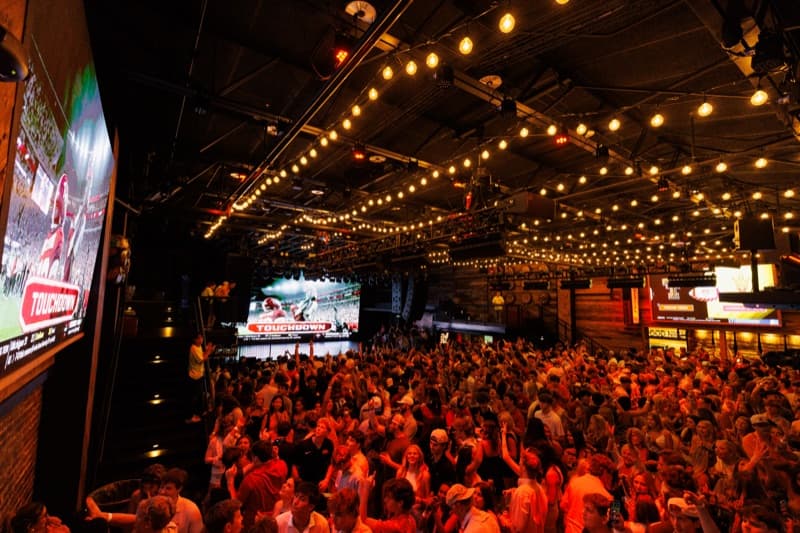 The floor at Two Dimes packed under string lights