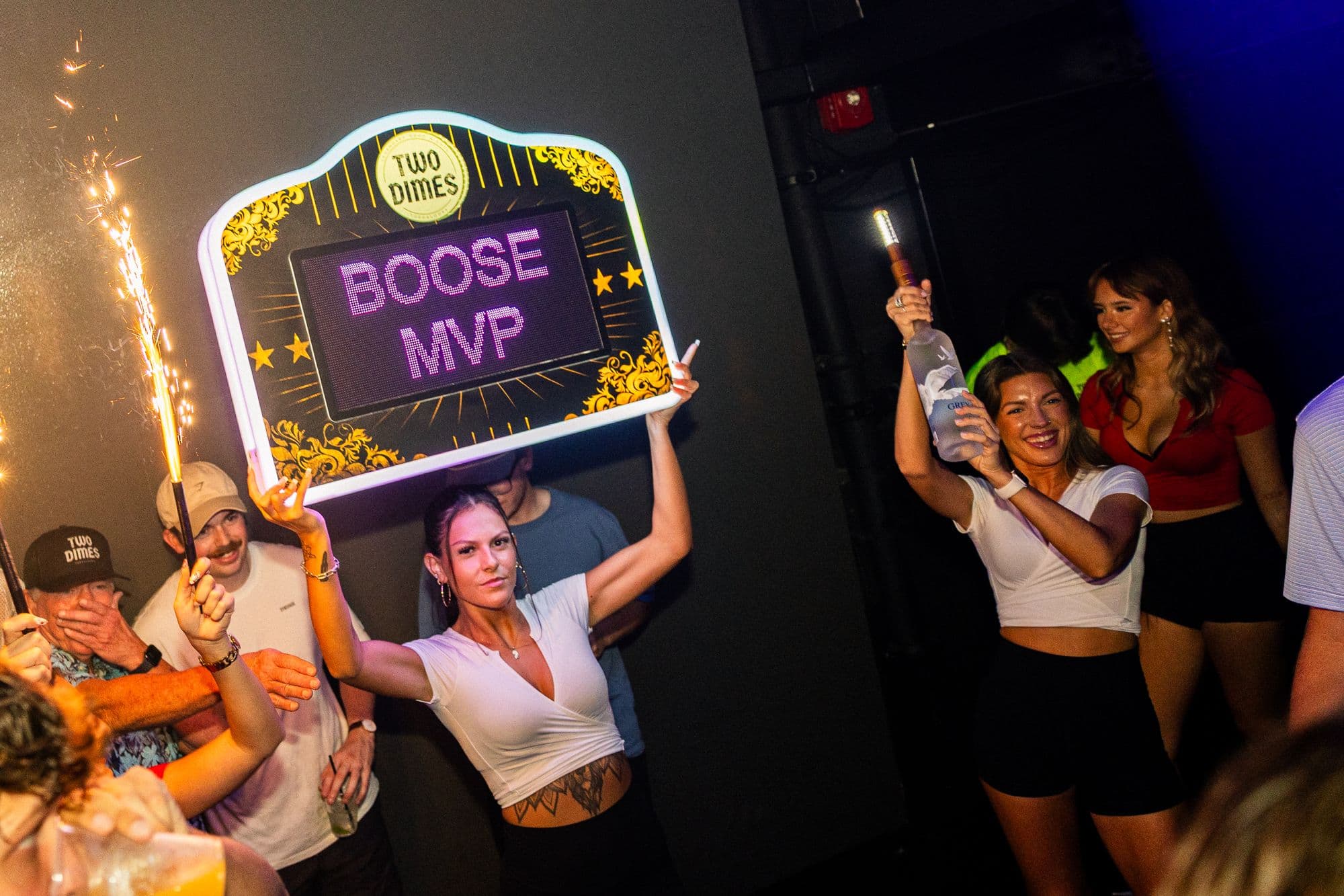 A custom lit sign delivered to a VIP table
