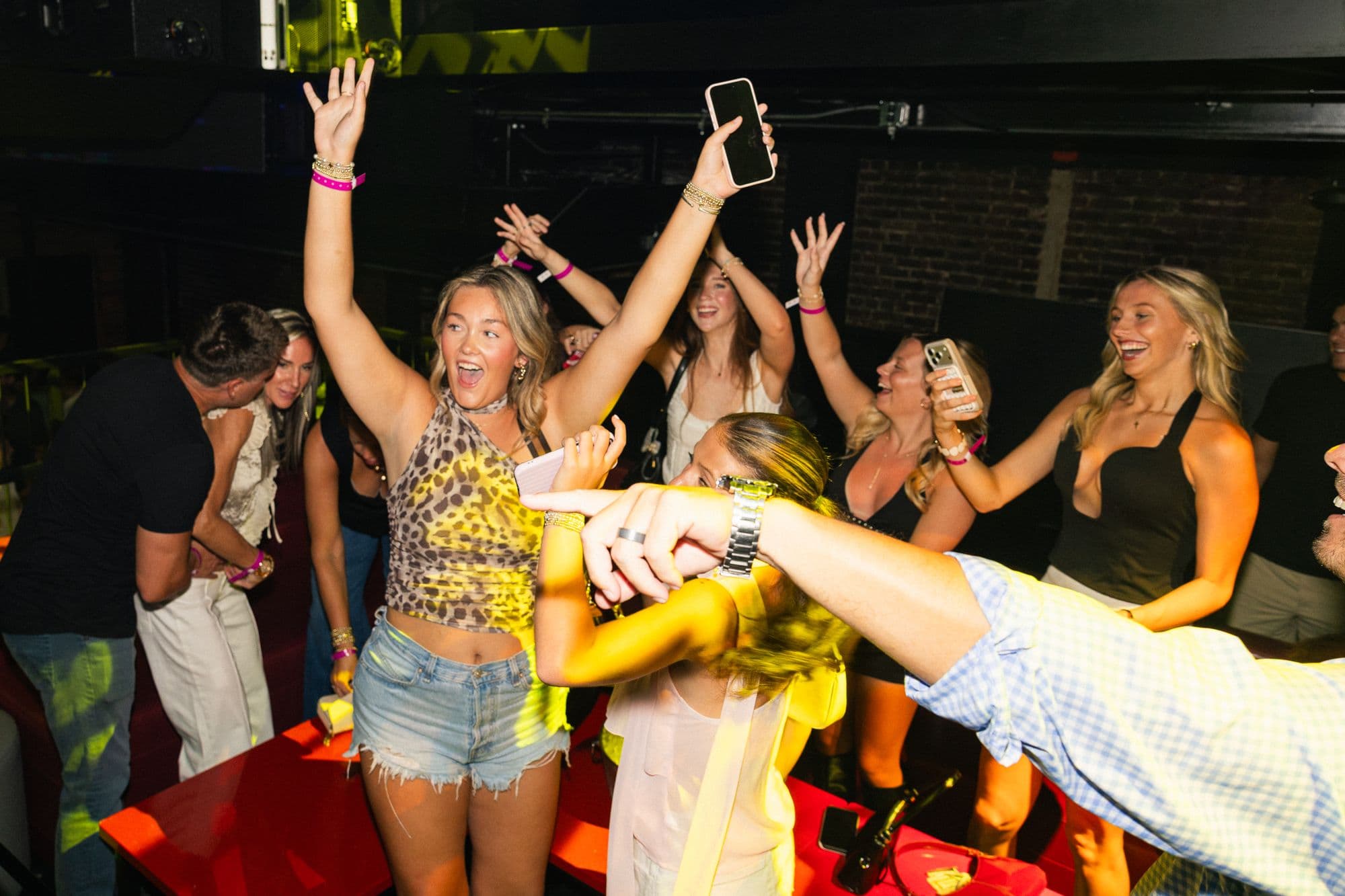 Guests celebrating in a VIP section beside the stage