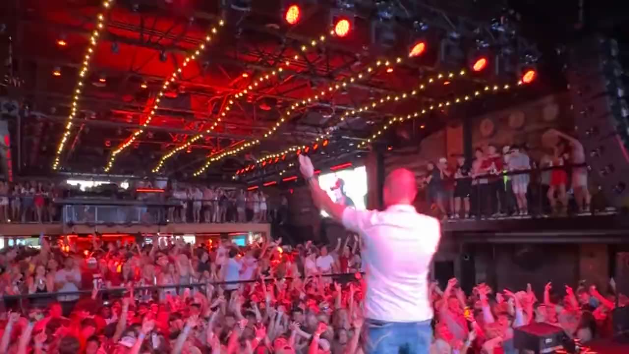 A packed house at Two Dimes — performer on stage over the crowd